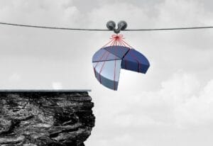 Graphic of pie chart sections being dangerously dangled over a cliff.