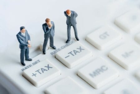 Miniature figures positioned on calculator