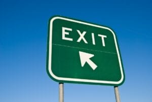 Green and white highway exit sign