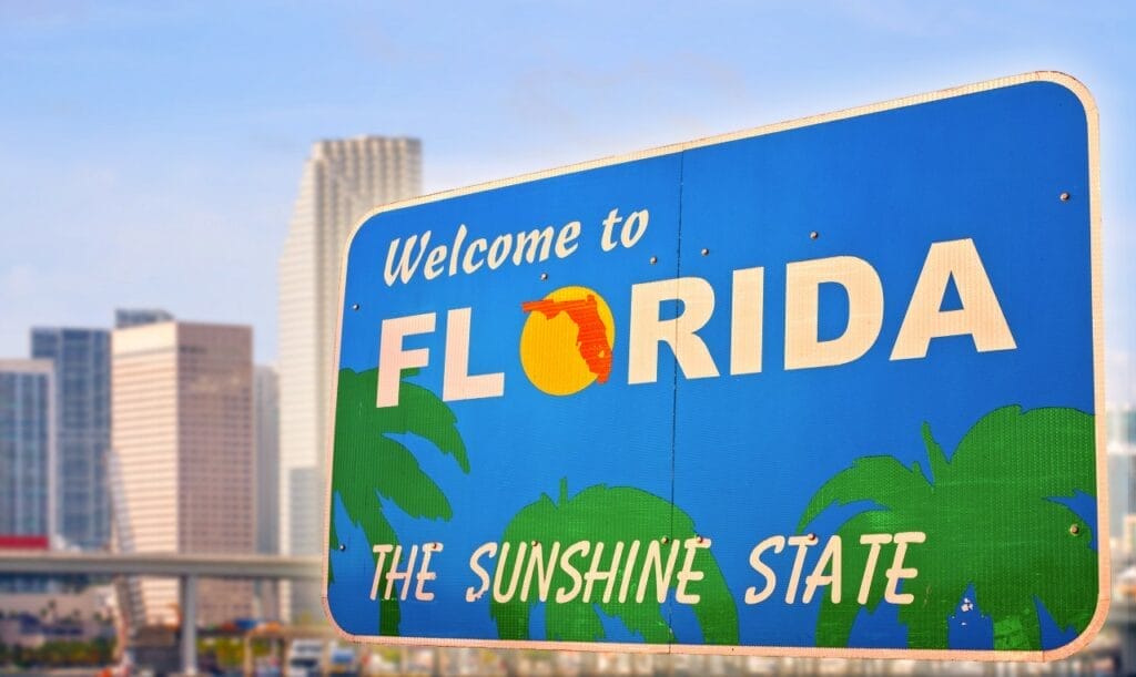 Welcome to Florida sign in front of city skyline