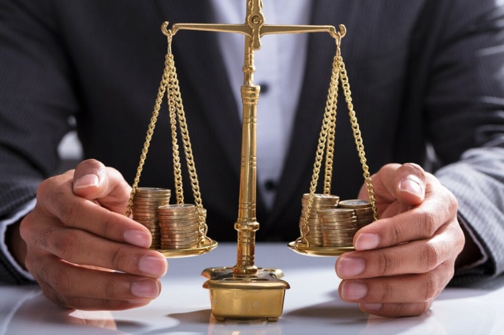 Man balancing scales of justice with coin currency