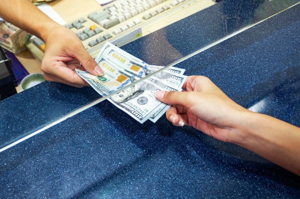 Person receiving cash from a bank or government agency