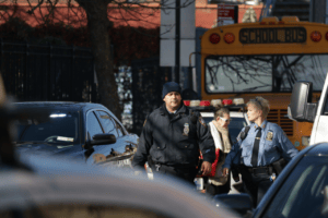 Police officer responding to incident near school bus