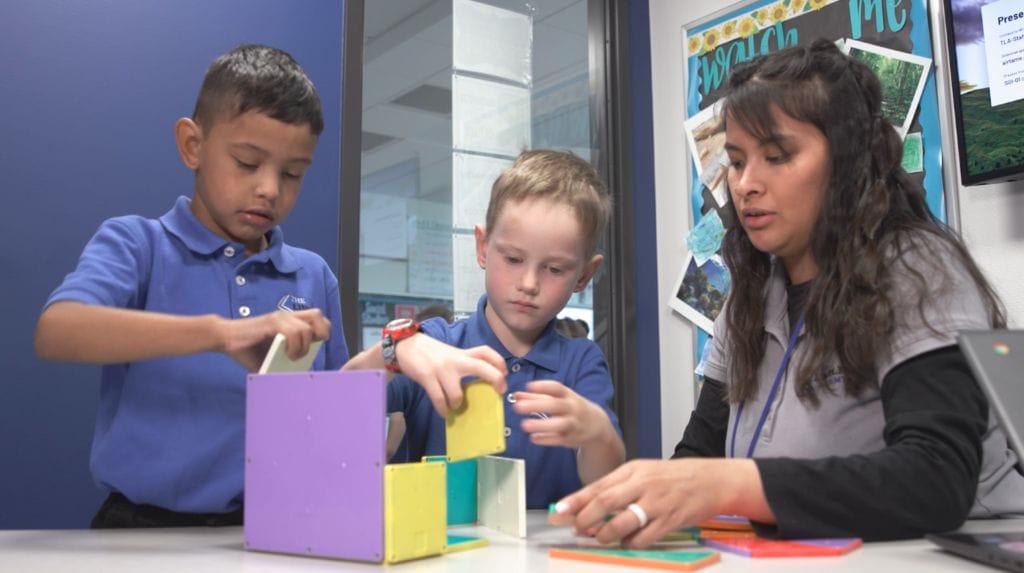 Teacher working with children during school day.