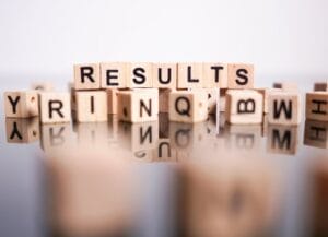Wooden letter blocks sequenced to read "results"