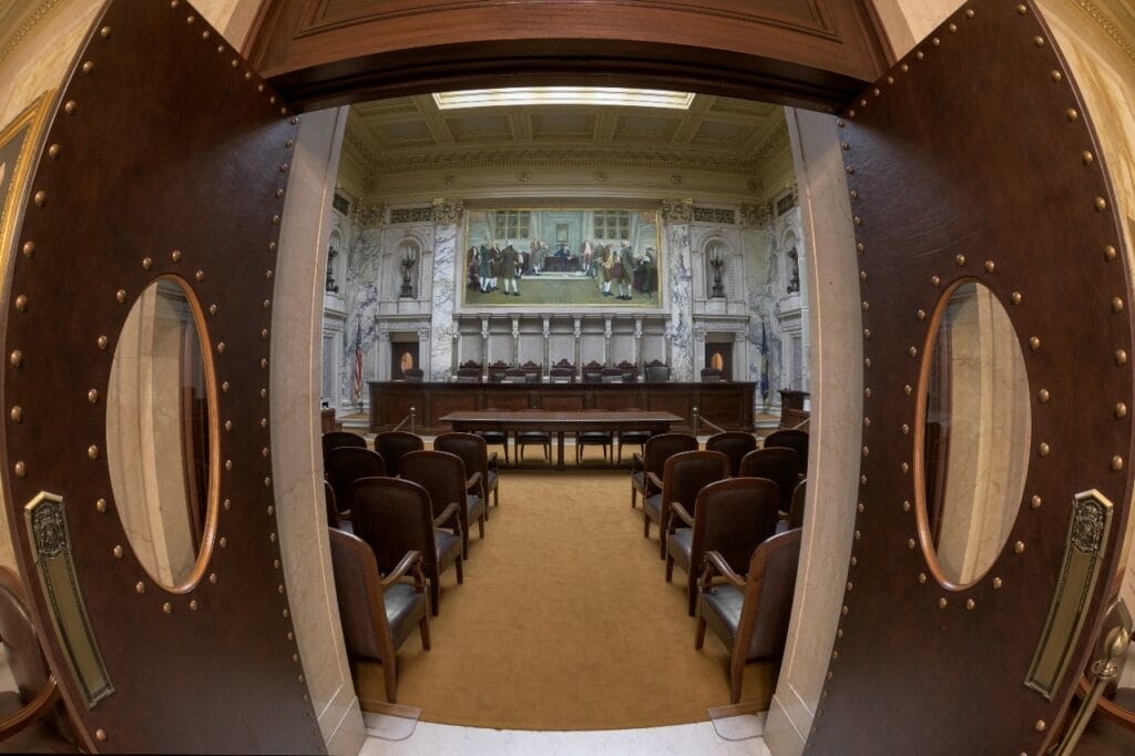 Photo looking through the doors of the Wisconsin Supreme Court where Janet Protasiewicz will likely hear challenges to the state’s abortion and voter ID laws.