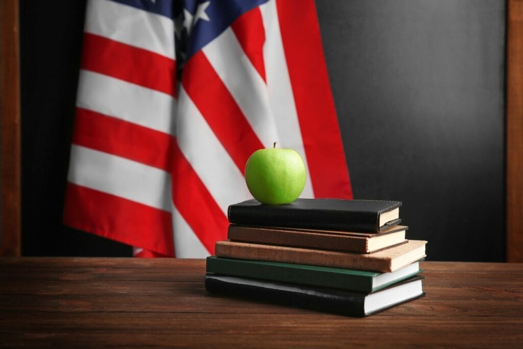 Apple atop a stack of books — representing the fruit of Wisconsin’s school choice funding reforms