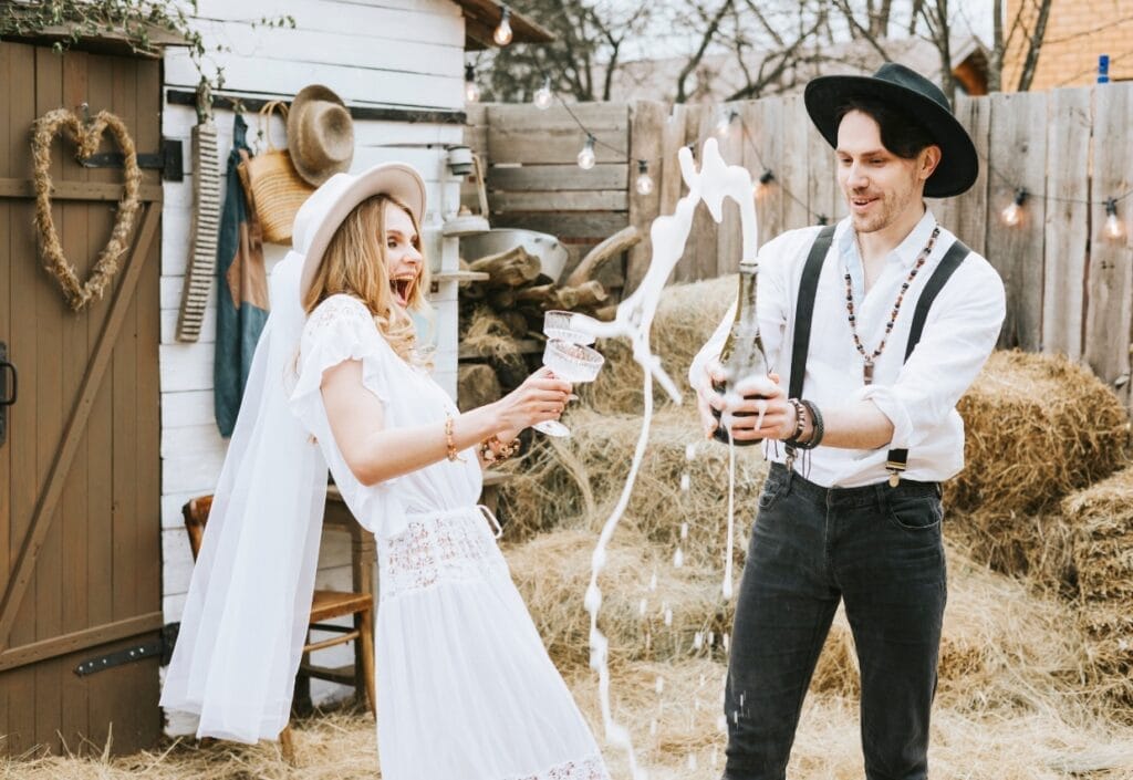 A Wisconsin couple drinking champagne at a wedding barn venue