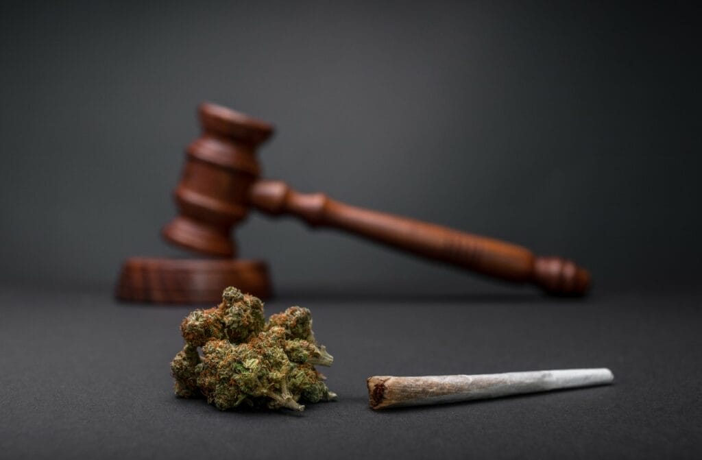 Judge's gavel next to marijuana bud and rolled joint indicating the lack criminal sentencing related to pot offenses in Wisconsin