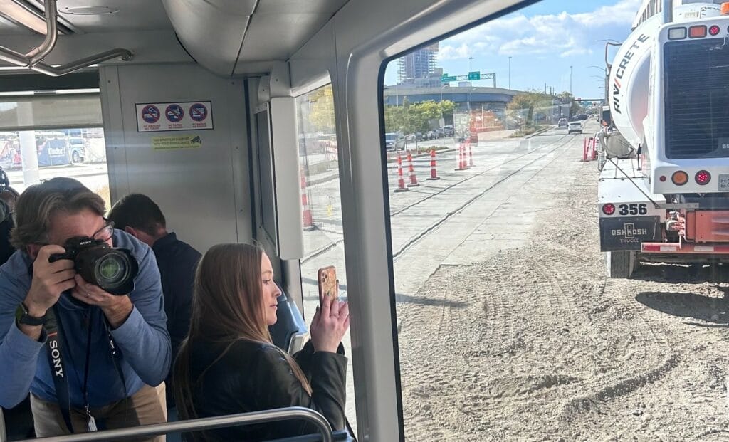 Photo of passengers riding The Hop’s L-Line through a Milwaukee construction site.