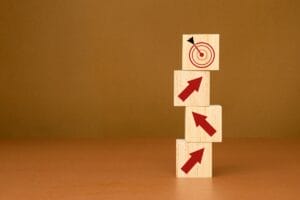 Image up blocks with upward arrows leading to a block with a target.