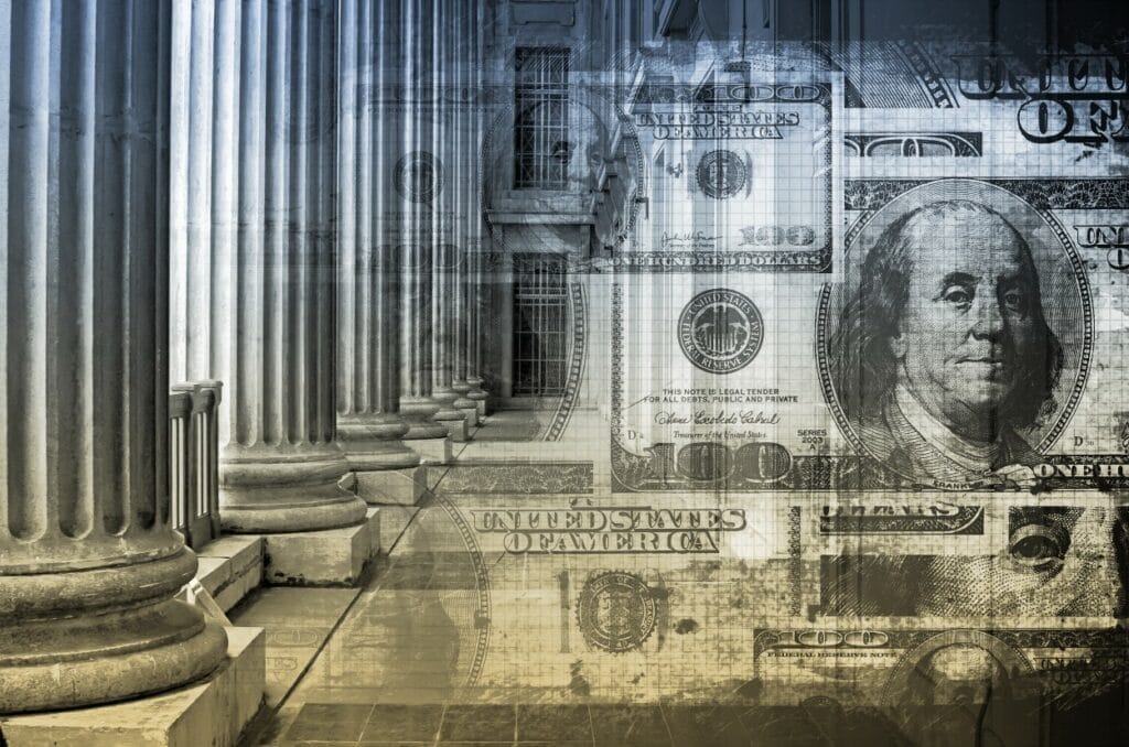 Image of $100 bills imposed over the halls of government, indicative of what Wisconsin will decide with an August 2024 constitutional amendment vote