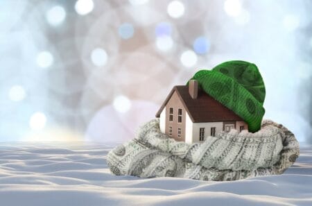 Rendering of a Wisconsin home wrapped in hat and scarf made of $100 bills — the consequence of a fossil fuel ban for home heating outlined in new research