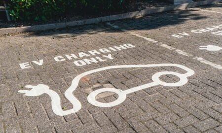 Parking stall painted with “EV Charing Only” and an image of an electric vehicle