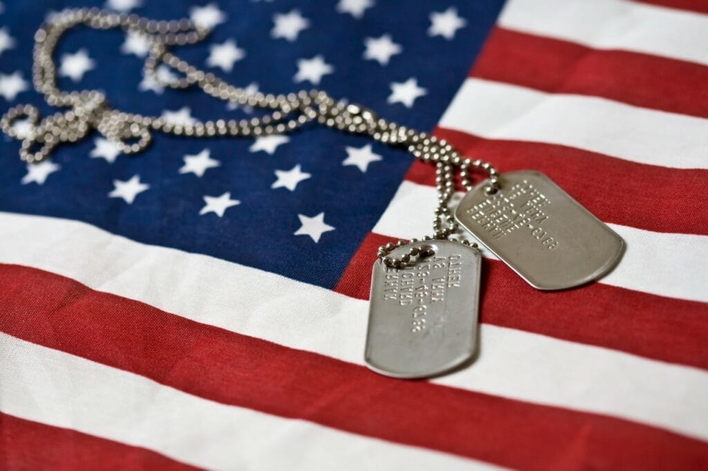 Dog tags positioned over an American flag