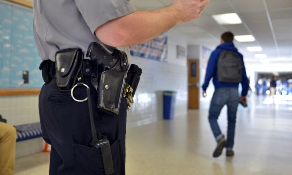 Image of school resource officer in high school hallway