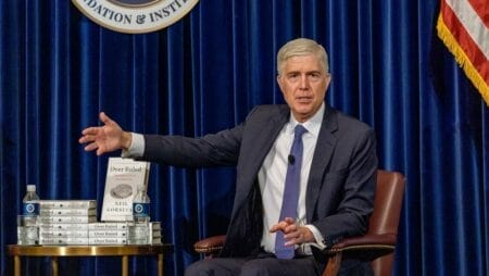 U.S. Supreme Court Justice Neil Gorsuch with his book that cites Badger Institute research on federalism and spending.