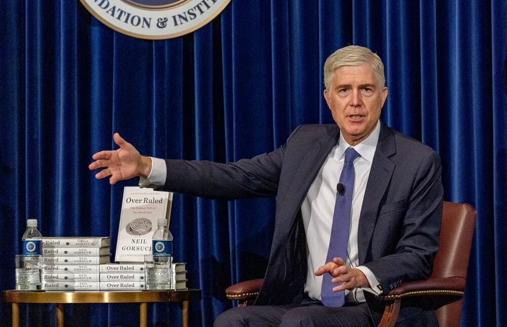 U.S. Supreme Court Justice Neil Gorsuch with his book that cites Badger Institute research on federalism and spending.